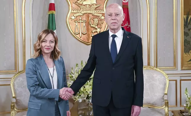 In this photo provided by the Tunisian Presidency, Tunisian President Kais Saied, right, shakes hands with Italian Prime Minister Giorgia Meloni, in Tunis, Wednesday April 17, 2024. Meloni and Saied signed new accords part of Italy's larger "Mattei Plan" for Africa, a continent-wide strategy aimed at growing economic opportunities and preventing migration from Africa to Europe.(Slim Abid/ Tunisian Presidential Palace via AP)