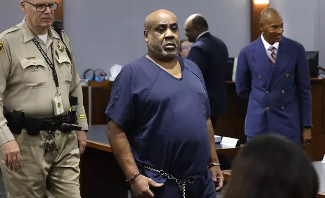 Duane “Keffe D” Davis, who is accused of orchestrating the 1996 slaying of hip-hop icon Tupac Shakur, center, and his attorney Carl Arnold, right, appear in court during a status hearing at the Regional Justice Center, on Tuesday, April 23, 2024, in Las Vegas. (Bizuayehu Tesfaye/Las Vegas Review-Journal via AP)