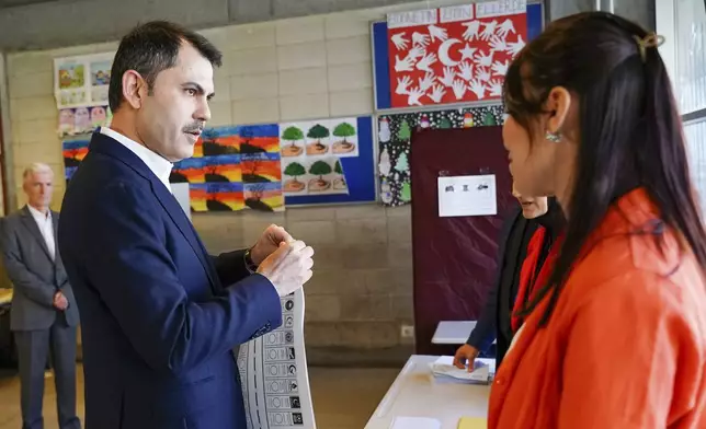 Justice and Development Party, or AKP, candidate for Istanbul Murat Kurum holds a ballot before voting at a polling station in Istanbul, Turkey, Sunday, March 31, 2024. Turkey is holding local elections on Sunday that will decide who gets to control Istanbul and other key cities. (Sercan Ozkurnazli/Dia Images via AP)