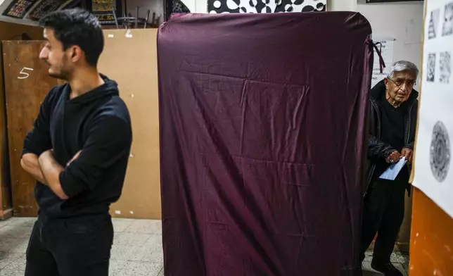 A man votes at a polling station in Istanbul, Turkey, Sunday, March 31, 2024. Turkey is holding local elections on Sunday that will decide who gets to control Istanbul and other key cities. (AP Photo/Emrah Gurel)