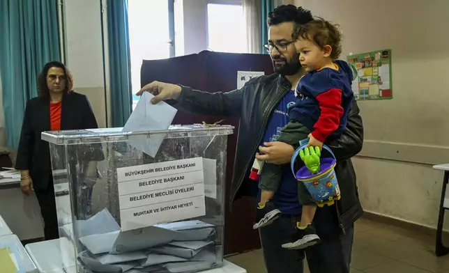 A man votes at a polling station in Ankara, Sunday, March 31, 2024. Turkey is holding local elections on Sunday that will decide who gets to control Istanbul and other key cities. (AP Photo/Ali Unal)