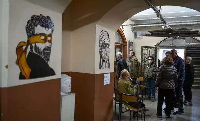 People wait to vote at a polling station in Istanbul, Turkey, Sunday, March 31, 2024. Turkey is holding local elections on Sunday that will decide who gets to control Istanbul and other key cities. (AP Photo/Emrah Gurel)