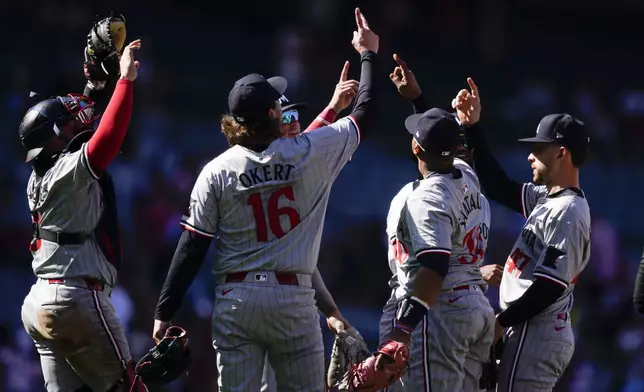 The Minnesota Twins celebrate after their win over the Los Angeles Angels in a baseball game, Sunday, April 28, 2024, in Anaheim, Calif. (AP Photo/Ryan Sun)