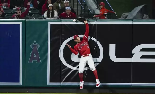 Los Angeles Angels left fielder Taylor Ward can't catch the ball on a double by Minnesota Twins' Edouard Julien, during the seventh inning of a baseball game Saturday, April 27, 2024, in Anaheim, Calif. Two runs scored. (AP Photo/Ryan Sun)