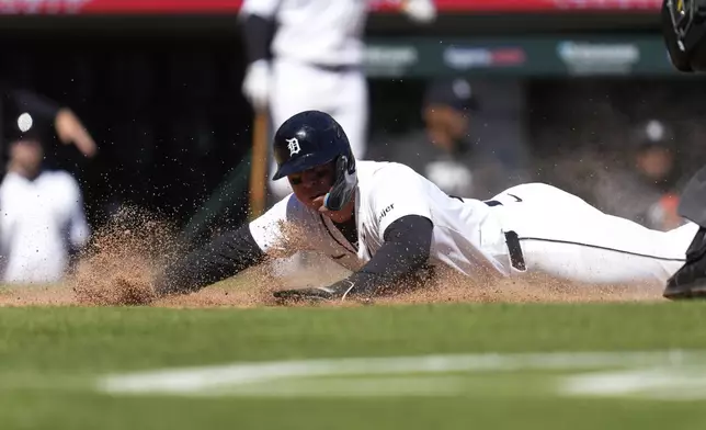 Detroit Tigers' Spencer Torkelson scores against the Minnesota Twins in the 11th inning during the first baseball game of a doubleheader, Saturday, April 13, 2024, in Detroit. (AP Photo/Paul Sancya)