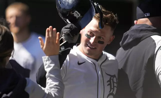 Detroit Tigers' Spencer Torkelson celebrates scoring against the Minnesota Twins in the sixth inning during the first baseball game of a doubleheader, Saturday, April 13, 2024, in Detroit. (AP Photo/Paul Sancya)