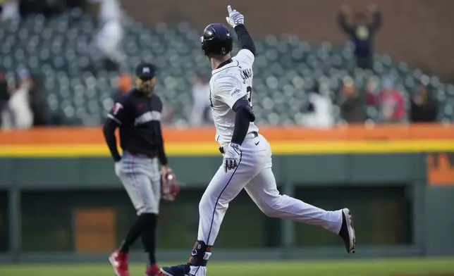 Detroit Tigers' Mark Canha points as he rounds the bases after a solo hoome run off Minnesota Twins pitcher Pablo López during the first inning of a baseball game, Friday, April 12, 2024, in Detroit. (AP Photo/Carlos Osorio)
