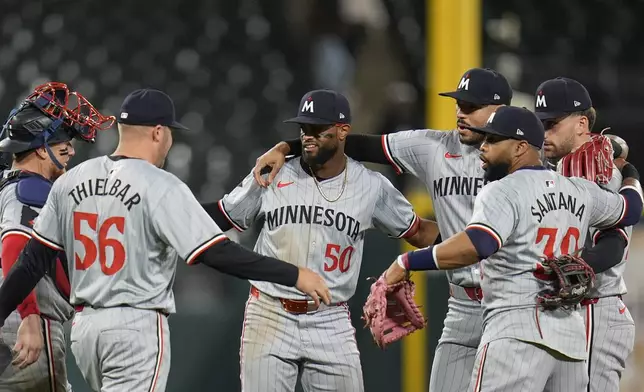 Minnesota Twins left fielder Willi Castro, center, and his teammates celebrate their 3-2 win over the Chicago White Sox during the ninth inning of a baseball game Monday, April 29, 2024, in Chicago. (AP Photo/Erin Hooley)