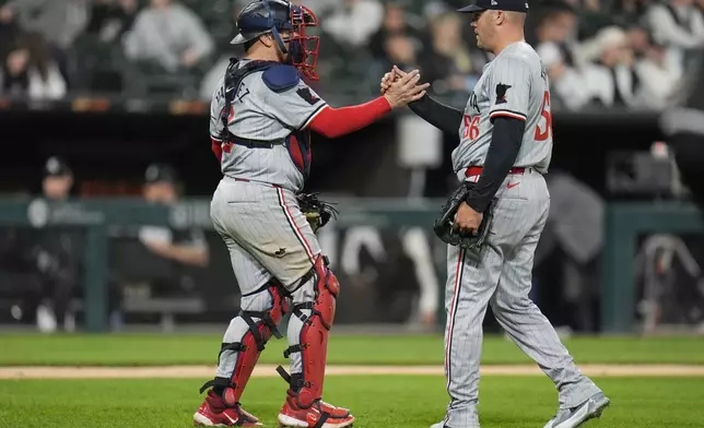 Minnesota Twins catcher Christian Vázquez, left, and closing pitcher Caleb Thielbar celebrate their team's 3-2 win over the Chicago White Sox during the ninth inning of a baseball game Monday, April 29, 2024, in Chicago. (AP Photo/Erin Hooley)