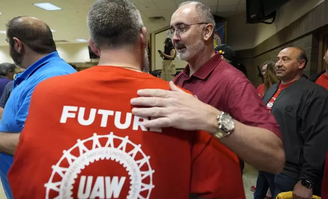UAW president Shawn Fain, right, greets Volkswagen auto workers after winning their vote to join the union Friday, April 19, 2024, in Chattanooga, Tenn. (AP Photo/George Walker IV)
