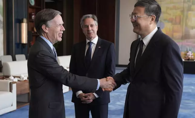 U.S. Secretary of State Antony Blinken, center, watches U.S. Ambassador to China Nicholas Burns, left, shake hands with Shanghai Party Secretary Chen Jining at the Grand Halls, Thursday, April 25, 2024, in Shanghai, China. (AP Photo/Mark Schiefelbein, Pool)