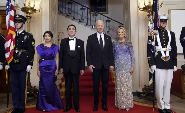 President Joe Biden and first lady Jill Biden pose for a photo with Japanese Prime Minister Fumio Kishida and his wife Yuko Kishida by the Grand Staircase in the Cross Hall of the White House during a State Dinner at the White House, Wednesday, April 10, 2024, in Washington. (AP Photo/Evan Vucci)