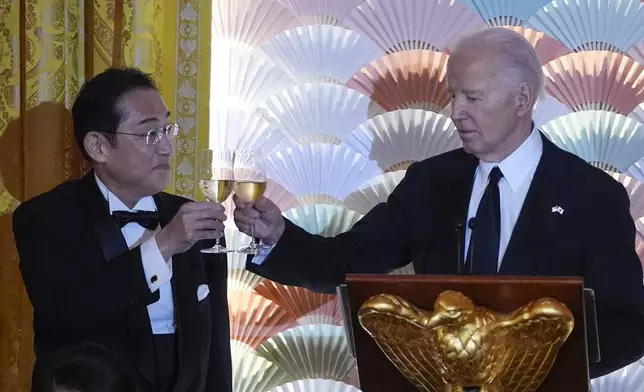 President Joe Biden makes a toast with Japanese Prime Minister Fumio Kishida during a State Dinner at the White House, Wednesday, April 10, 2024, in Washington. (AP Photo/Evan Vucci)