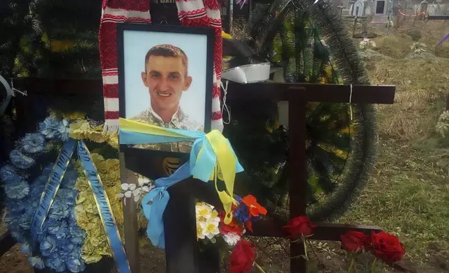 This photo provided by the family shows the grave of Oleksandr “Sasha” Romanovych Hrysiuk, who was buried in Kvitneve, Ukraine, in March 2023. Olha visits her son’s grave every day, to sit with him, talk with him and pray that he – and perhaps she herself -- finds peace. (Courtesy Olha Hrysiuk via AP)