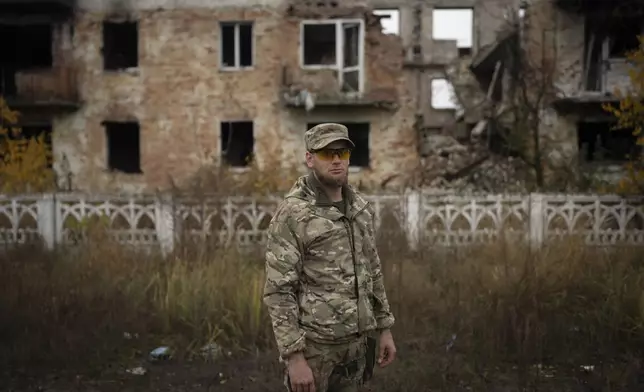 Oleksii Yukov, a Ukrainian body collector, stands for a portrait in the Sloviansk region, Ukraine, Tuesday, Oct. 24, 2023. He tells the mothers of those killed to talk about their dead children, so they will be remembered. (AP Photo/Bram Janssen)