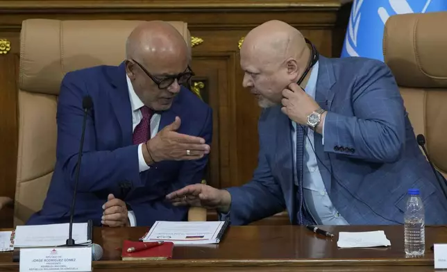 Karim Khan, chief prosecutor of International Criminal Court, right, speaks with National Assembly President Jorge Rodriguez at the National Assembly in Caracas, Venezuela, Monday, April 22, 2024. (AP Photo/Ariana Cubillos)
