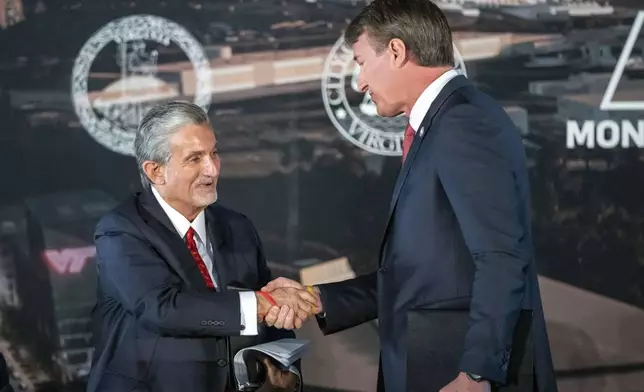 FILE - Ted Leonsis, left, owner of the Washington Wizards NBA basketball team and Washington Capitals HNL hockey team, shakes hands with Virginia Gov. Glenn Youngkin as they announce plans for a new sports stadium for the teams, Wednesday, Dec. 13, 2023, in Alexandria, Va. Negotiations to lure the Capitals and Wizards to northern Virginia have “ended” and the proposal to create a development district with a new arena for the teams "will not move forward,” the city of Alexandria said in a statement Wednesday, Mach 27, 2024. (AP Photo/Alex Brandon, File)