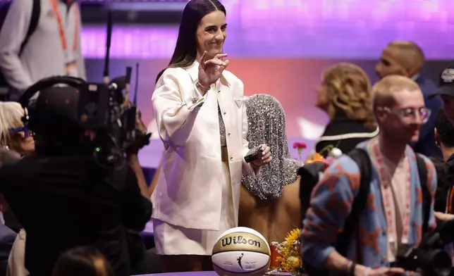 Iowa's Caitlyn Clark waves to fans before the start of the WNBA basketball draft, Monday, April 15, 2024, in New York. (AP Photo/Adam Hunger)