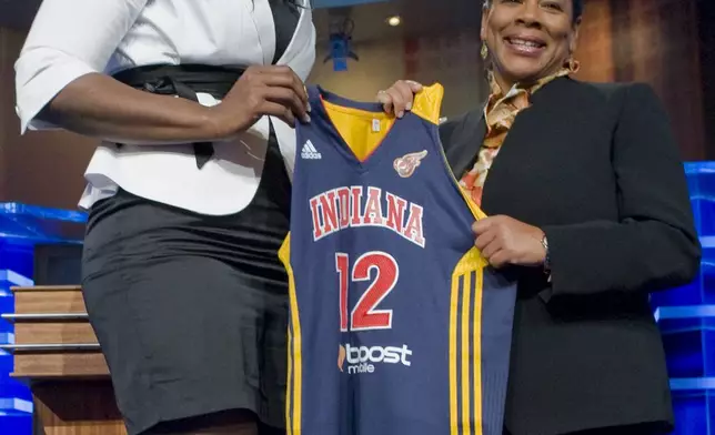 FILE - Georgia Tech's Sasha Goodlett, left, holds up an Indiana Fever jersey with WNBA president Laurel J. Richie after Indiana selected Goodlett as the No. 11 pick in the WNBA basketball draft in Bristol, Conn., April 16, 2012. Everyone likes to look good for a big night on the town. Lots of people will be watching as the WNBA’s next players turn out dressed in their finest looks for Monday night's April 15, 2024, draft. (AP Photo/Jessica Hill, File)