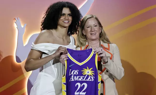 FILE - Tennessee's Rae Burrell, left, poses for a photo with commissioner Cathy Engelbert after being selected by the Los Angeles Sparks as the ninth overall pick in the WNBA basketball draft, April 11, 2022, in New York. Everyone likes to look good for a big night on the town. Lots of people will be watching as the WNBA’s next players turn out dressed in their finest looks for Monday night's April 15, 2024, draft. (AP Photo/Adam Hunger, File)