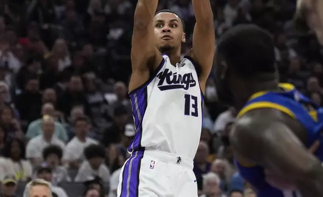 Sacramento Kings forward Keegan Murray, center, shoots a 3-point basket during the first half of an NBA basketball play-in tournament game against the Golden State Warriors, Tuesday, April 16, 2024, in Sacramento, Calif. (AP Photo/Godofredo A. Vásquez)