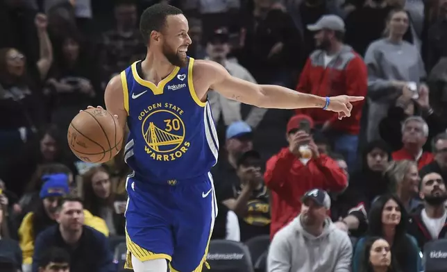 Golden State Warriors guard Stephen Curry smiles, at the end of the team's NBA basketball game against the Portland Trail Blazers in Portland, Ore., Thursday, April 11, 2024. (AP Photo/Steve Dykes)