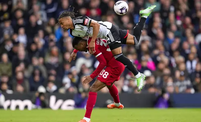 Fulham's Bobby Decordova-Reid, top, duels for the ball with Liverpool's Ryan Gravenberch during the English Premier League soccer match between Fulham and Liverpool at Craven Cottage stadium in London, Sunday, April 21, 2024. (AP Photo/Kirsty Wigglesworth)