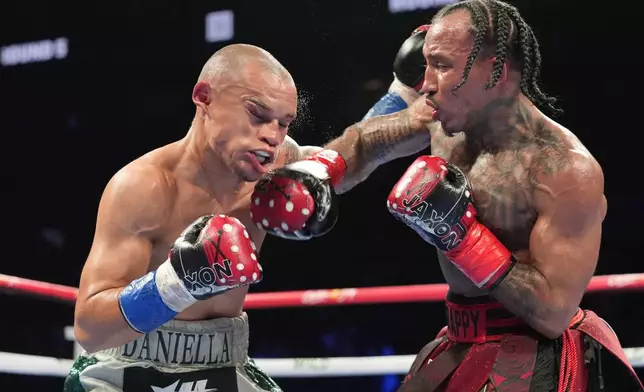 John Ramirez, right, punches Costa Rica's David Jimenez, left, during the fifth round of an interim world super flyweight title boxing match Saturday, April 20, 2024, in New York. Jimenez won the fight. (AP Photo/Frank Franklin II)