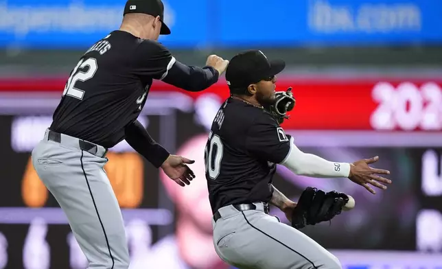 Chicago White Sox second baseman Lenyn Sosa, right, and right fielder Gavin Sheets collide trying to catch a single by Philadelphia Phillies' Johan Rojas during the seventh inning of a baseball game, Saturday, April 20, 2024, in Philadelphia. (AP Photo/Matt Slocum)