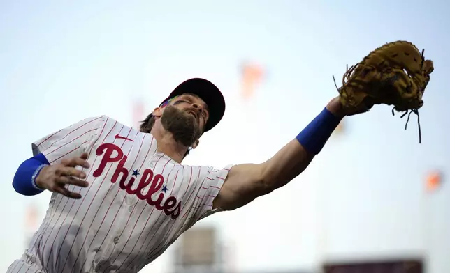 Philadelphia Phillies first baseman Bryce Harper catches a pop foul out by Chicago White Sox's Korey Lee during the fifth inning of a baseball game, Saturday, April 20, 2024, in Philadelphia. (AP Photo/Matt Slocum)