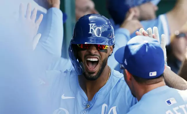 Kansas City Royals' MJ Melendez celebrates in the dugout after hitting a two-run home run during the seventh inning of a baseball game against the Chicago White Sox in Kansas City, Mo., Sunday, April 7, 2024. (AP Photo/Colin E. Braley)
