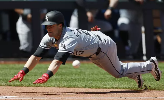 Chicago White Sox' Andrew Benintendi (23) beats the throw to score off a Dominic Fletcher triple during the fourth inning of a baseball game against the Kansas City Royals in Kansas City, Mo., Sunday, April 7, 2024. (AP Photo/Colin E. Braley)