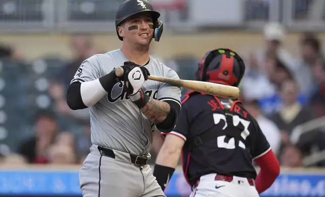 Chicago White Sox's Korey Lee, left, reacts after striking out to end the top of the third inning of a baseball game against the Minnesota Twins, Monday, April 22, 2024, in Minneapolis. (AP Photo/Abbie Parr)