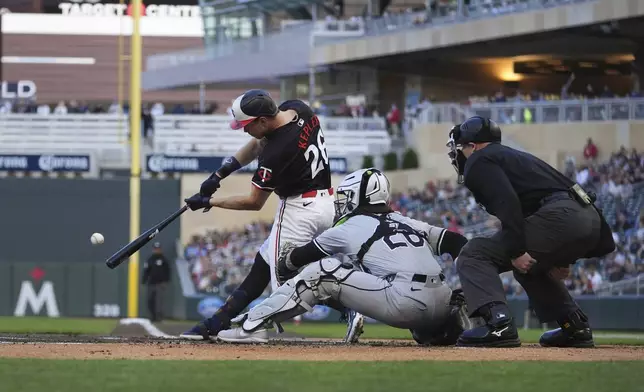 Minnesota Twins' Max Kepler (26) hits an RBI-double during the first inning of a baseball game against the Chicago White Sox, Monday, April 22, 2024, in Minneapolis. (AP Photo/Abbie Parr)