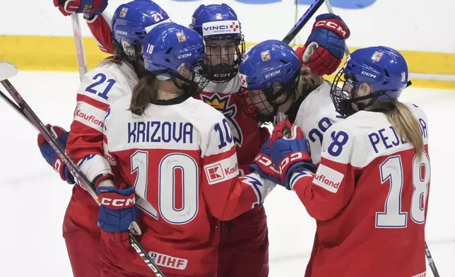 Czechia's Michaela Pejzlova (18) celebrates after her goal celebrates her goal over Finland with teammates during second-period bronze medal hockey game action at the women's world hockey championships in Utica, N.Y., Sunday, April 14, 2024. (Christinne Muschi/The Canadian Press via AP)