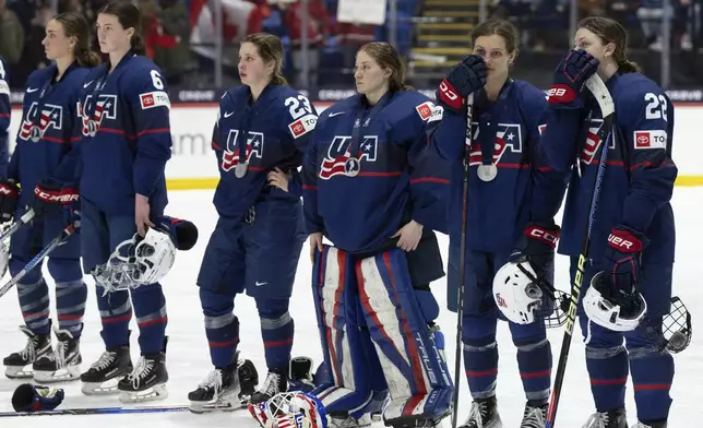 United States players react following their loss to Canada in the gold medal game at the women's world hockey championships in Utica, N.Y., Sunday, April 14, 2024. (Christinne Muschi/The Canadian Press via AP)