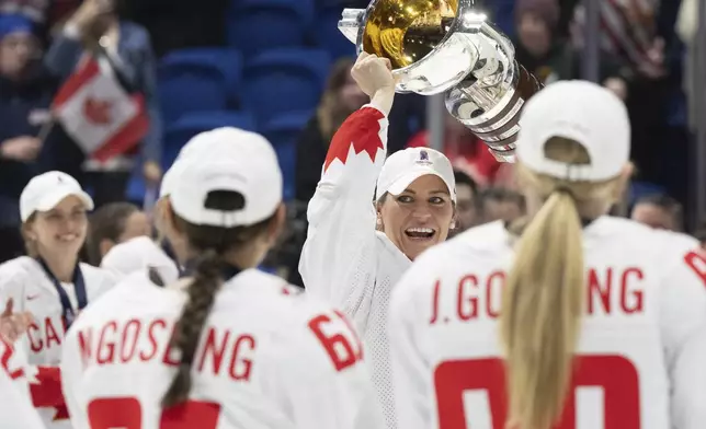 Canada's Marie-Philip Poulin lifts the trophy following their gold medal win over United States at the women's world hockey championships in Utica, N.Y., Sunday, April 14, 2024. (Christinne Muschi/The Canadian Press via AP)