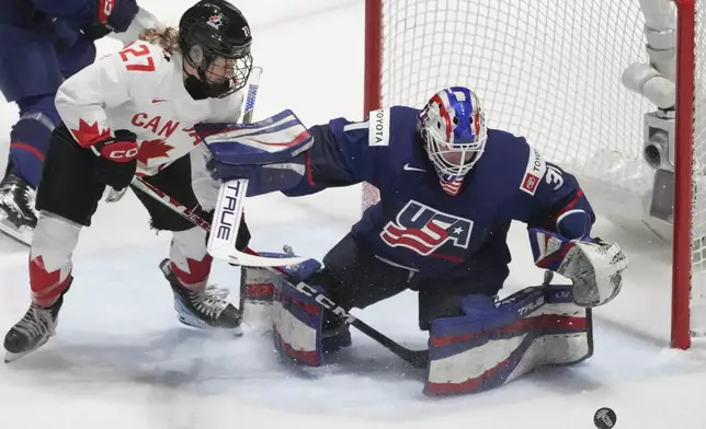 United States goaltender Aerin Frankel (31) makes a save over Canada's Emma Maltais (27) during the first period in the final at the IIHF Women's World Hockey Championships in Utica, N.Y., Sunday, April 14, 2024. (Christinne Muschi/The Canadian Press via AP)