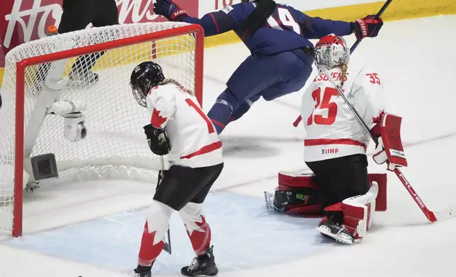 United States' Laila Edwards (14) scores on Canada goaltender Ann-Renee Desbiens (35) during the first period in the final at the IIHF Women's World Hockey Championships in Utica, N.Y., Sunday, April 14, 2024. (Christinne Muschi/The Canadian Press via AP)