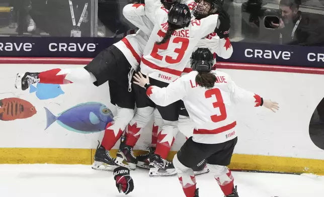 Canada's Danielle Serdachny celebrates her overtime goal over the United States with teammates in their gold medal game at the women's world hockey championships in Utica, N.Y., Sunday, April 14, 2024. (Christinne Muschi/The Canadian Press via AP)