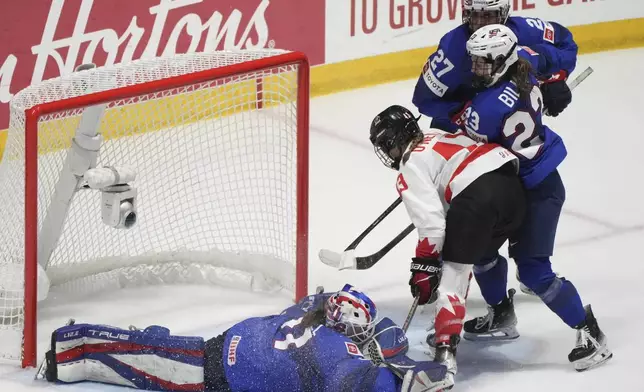 United States goaltender Aerin Frankel (31) makes a save over Canada's Kristin O'Neill (43) during the second period of a hockey game at the IIHF Women's World Hockey Championship in Utica, N.Y., Monday, April 8, 2024. (Christinne Muschi/The Canadian Press via AP)