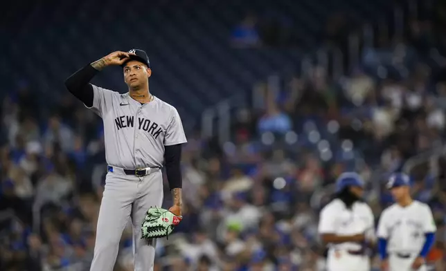 New York Yankees pitcher Luis Gil reacts during the first inning of a baseball game against the Toronto Blue Jays in Toronto on Monday, April 15, 2024. (Christopher Katsarov/The Canadian Press via AP)
