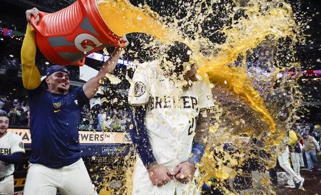 Milwaukee Brewers' Willy Adames douses Joey Ortiz after a walk off hit during the 11th inning of a baseball game against the New York Yankees Friday, April 26, 2024, in Milwaukee. The Brewers won 7-6. (AP Photo/Morry Gash)