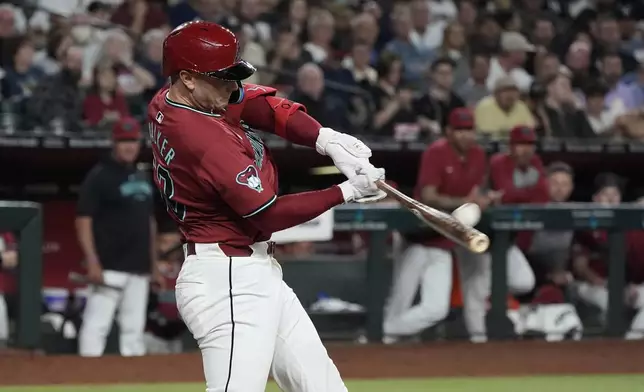 Arizona Diamondbacks' Christian Walker connects for a three-run home run against the New York Yankees during the seventh inning of a baseball game Tuesday, April 2, 2024, in Phoenix. (AP Photo/Ross D. Franklin)