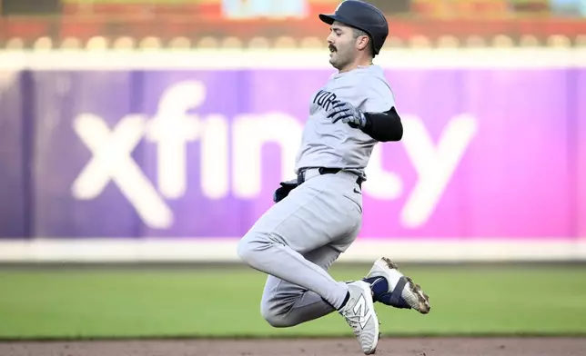 New York Yankees' Austin Wells starts his slide toward second base on his double during the second inning of a baseball game against the Baltimore Orioles, Monday, April 29, 2024, in Baltimore. (AP Photo/Nick Wass)