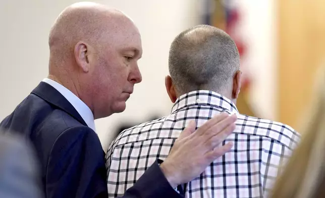 Attorney Rus Rilee, left, comforts his client, David Meehan, before Meehan took the stand in his civil trial against the Youth Development Center in his civil trial at Rockingham County Superior Court in Brentwood, N.H. on Wednesday, April 17, 2024. (David Lane/Union Leader via AP, Pool)