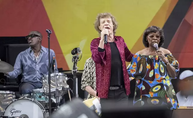 Steve Jordan, left, Mick Jagger and Irma Thomas perform with the Rolling Stones during the New Orleans Jazz &amp; Heritage Festival on Thursday, May 2nd, 2024, at the Fair Grounds Race Course in New Orleans. (Photo by Amy Harris/Invision/AP)