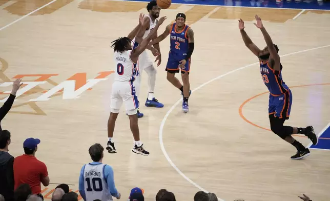 Philadelphia 76ers' Tyrese Maxey (0) shoots over New York Knicks' Mitchell Robinson (23) during the overtime period of Game 5 in an NBA basketball first-round playoff series, Tuesday, April 30, 2024, in New York. The 76ers won 112-106 in overtime. (AP Photo/Frank Franklin II)