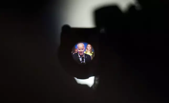 FILE - President Joe Biden is seen through a TV camera viewfinder as he speaks during a political rally at the Philadelphia Convention Center in Philadelphia, Saturday, June 17, 2023. “It’s really hard to tell the story of how generative AI is a net positive when so many bad actors – whether that’s robocalls, fake images or false video clips – are using the bad set of AI against us,” said a Democratic strategist close to the Biden campaign who would only discuss what was described as a sensitive topic if granted anonymity. (AP Photo/Joe Lamberti, File)