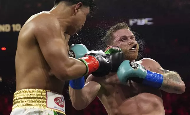 Jaime Munguia lands a left to Canelo Alvarez in a super middleweight title fight Saturday, May 4, 2024, in Las Vegas. (AP Photo/John Locher)